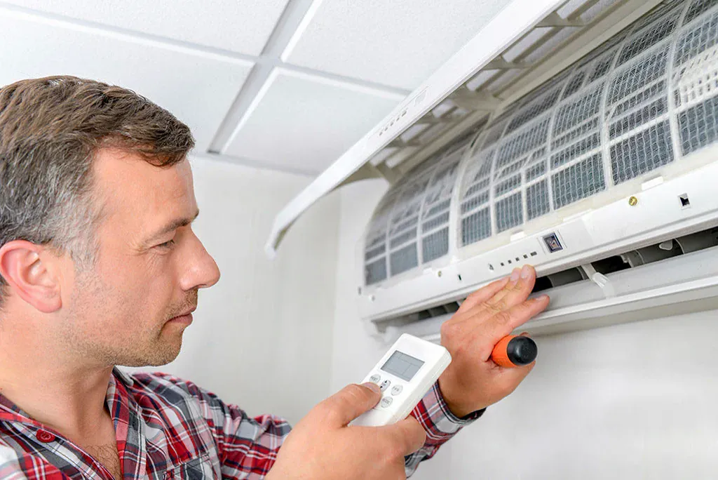 Technician running diagnostics on an indoor heat pump air handler